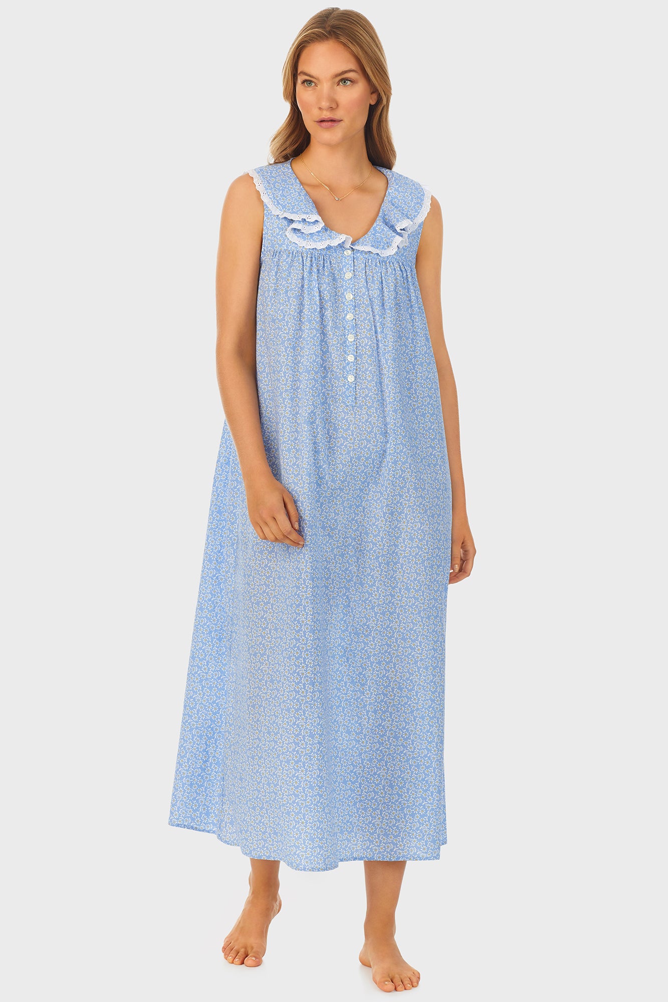 A lady wearing blue long nightgown with a white pattern.