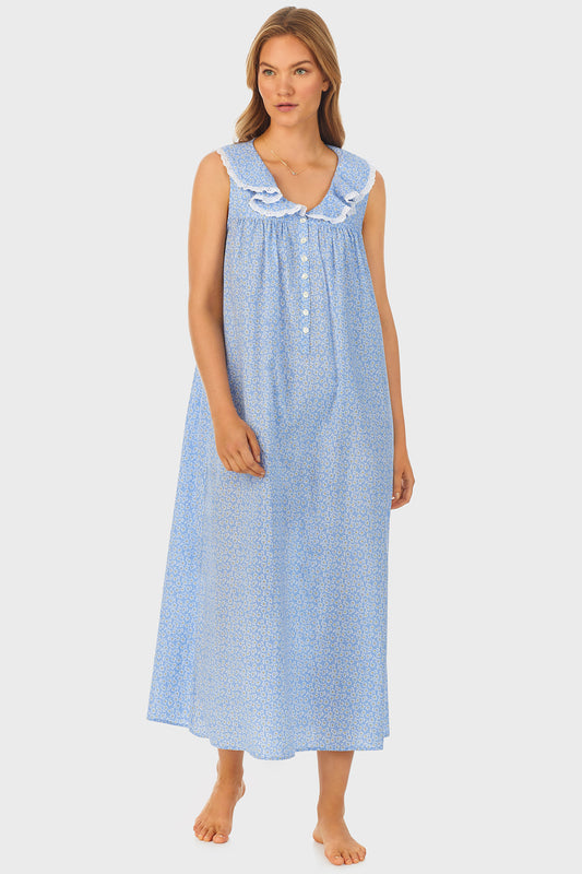 A lady wearing blue long nightgown with a white pattern.
