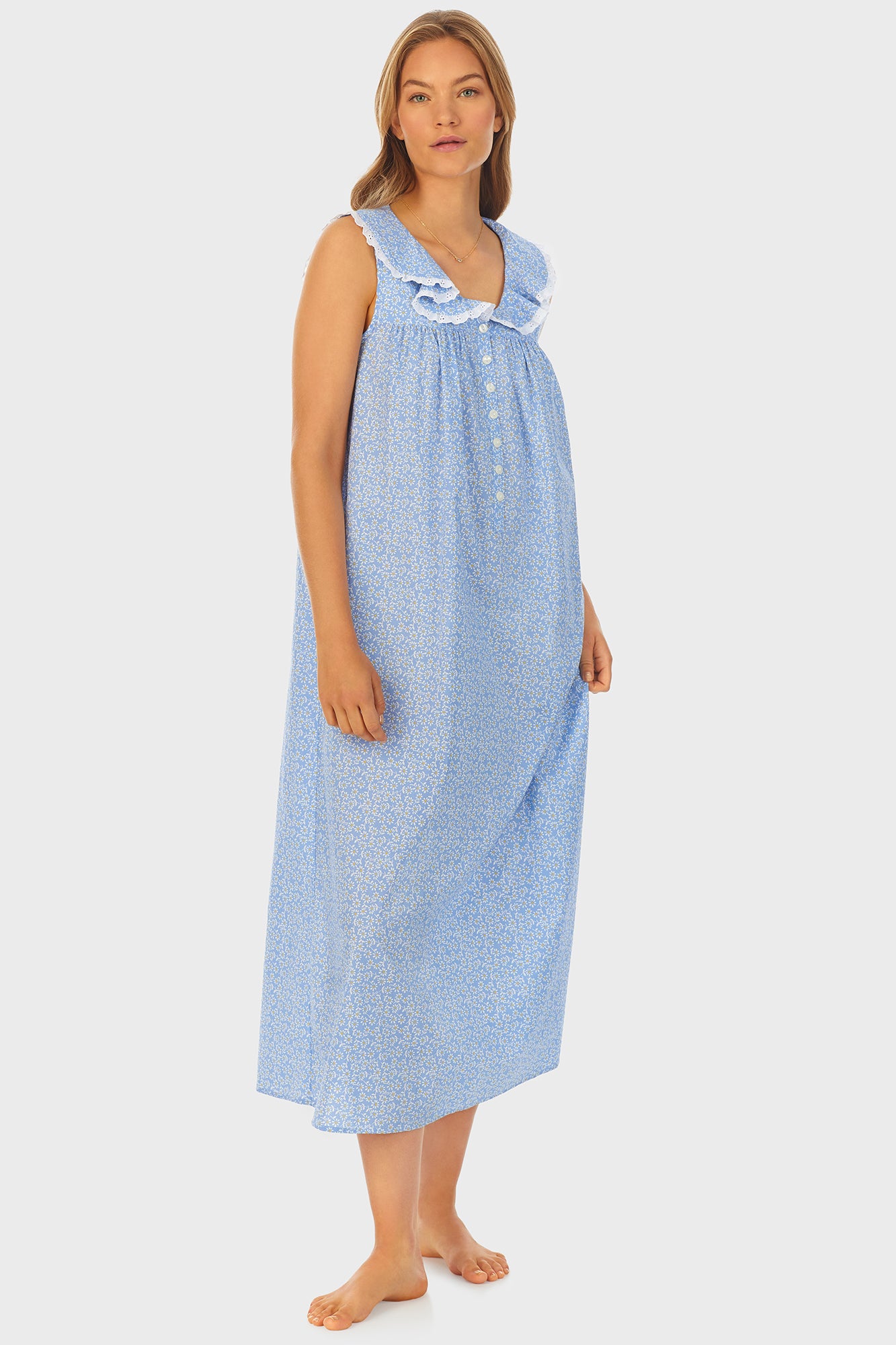 A lady wearing blue long nightgown with a white pattern.