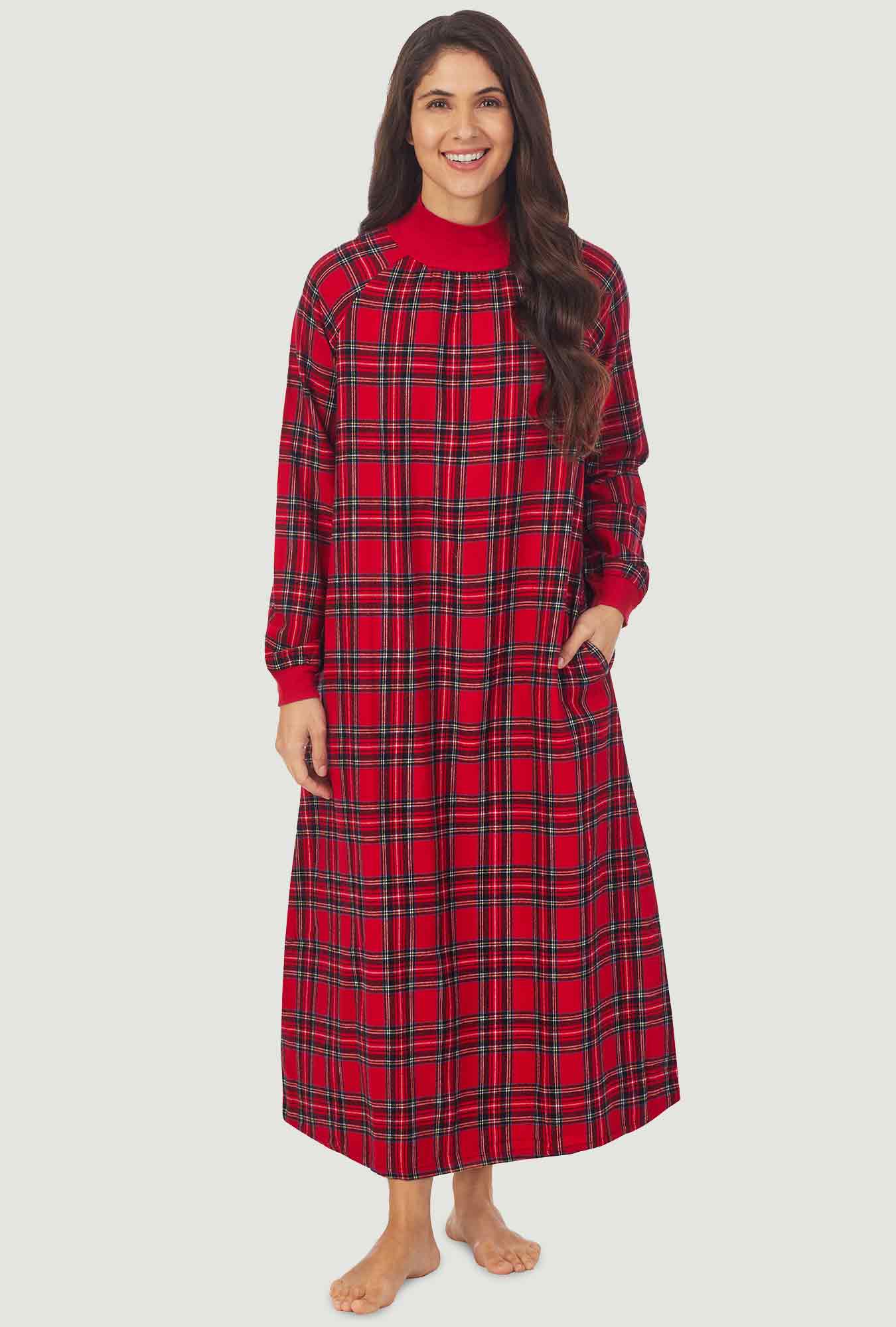 A lady wearing a red tartan long sleeve pop over flannel gown.