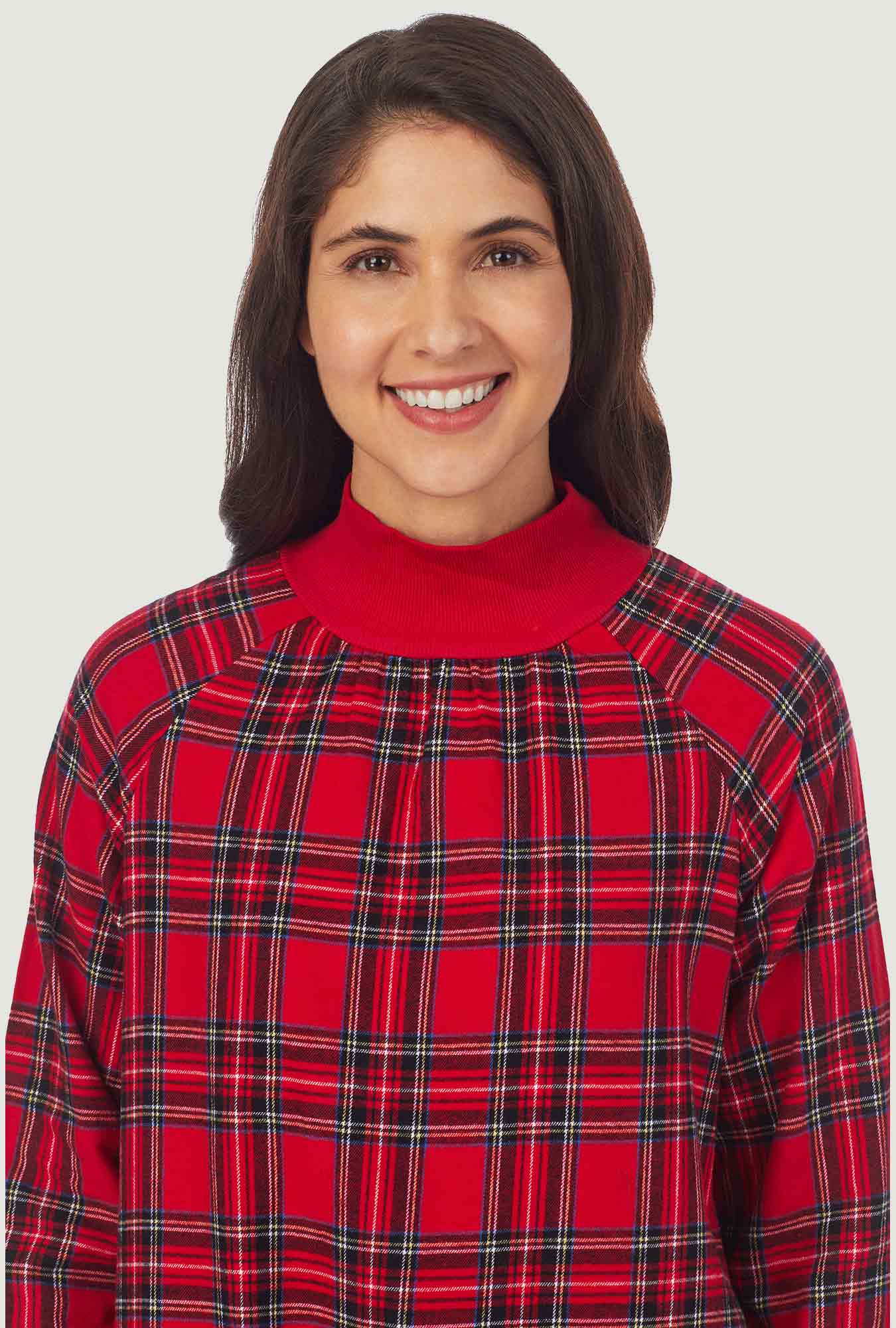 A lady wearing a red tartan long sleeve pop over flannel gown.