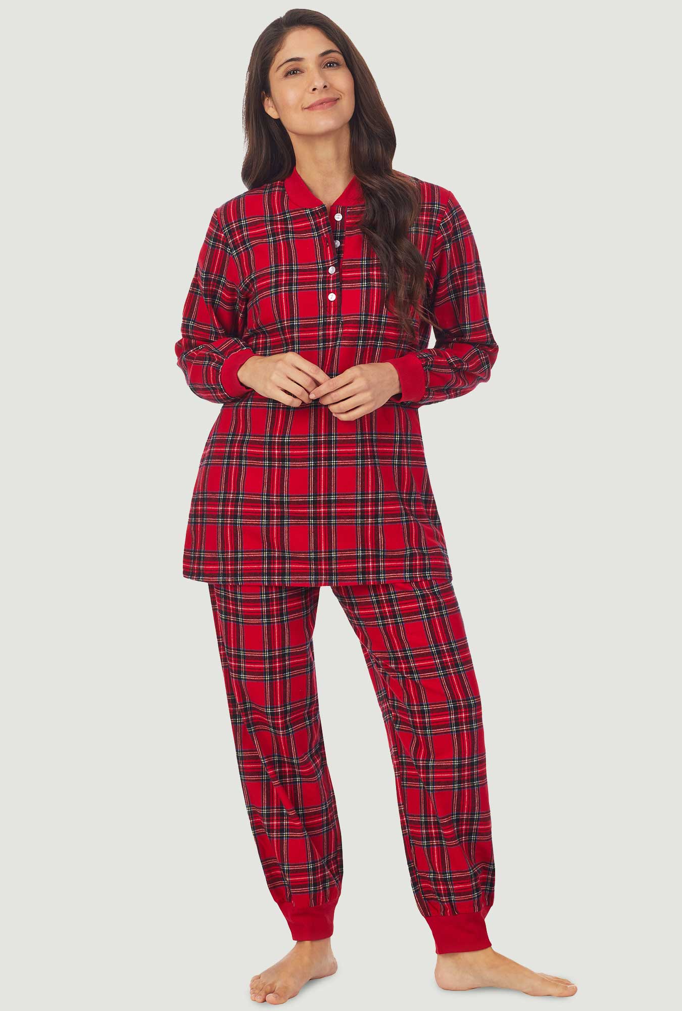 A lady wearing a red tartan long sleeve ski pajama.