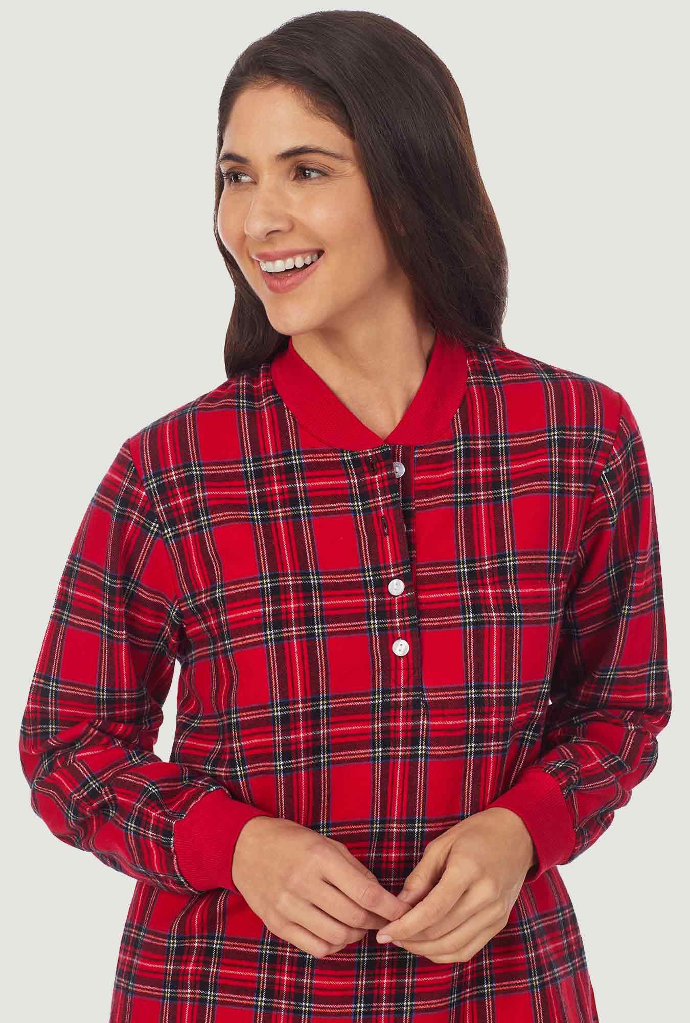 A lady wearing a red tartan long sleeve ski pajama.