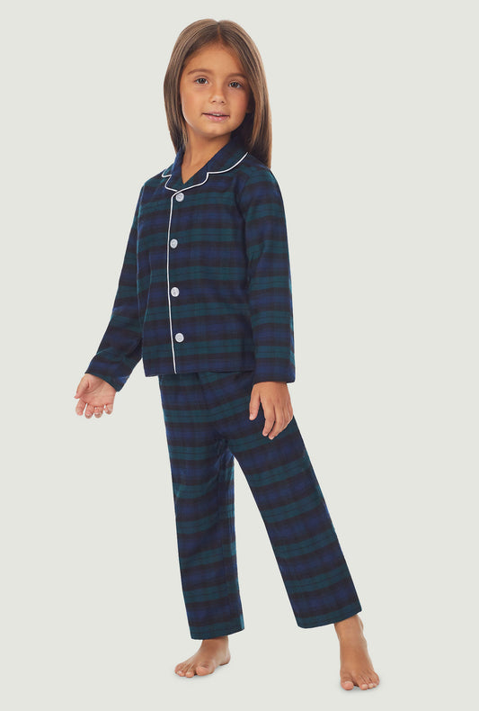  A kid wearing a long sleeve pajama set with black watch plaid pattern.