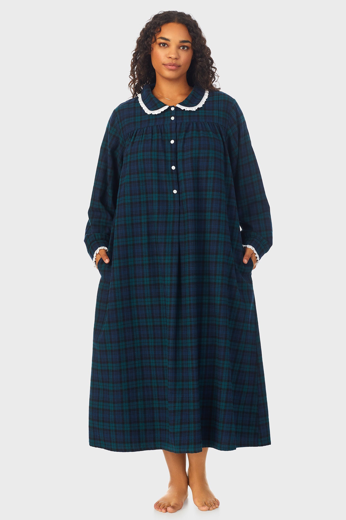 A lady wearing a long sleeve flannel gown plus with black watch peterpan pattern.