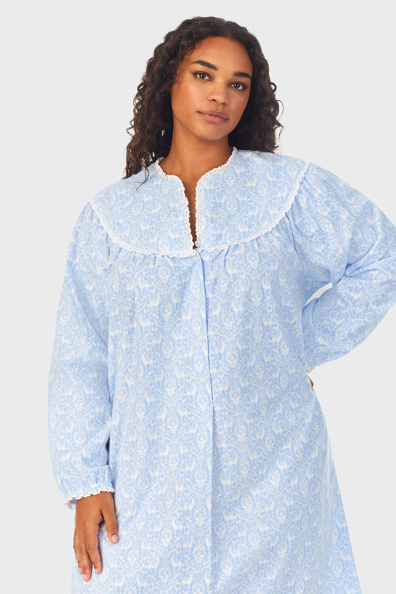 A lady wearing a blue long sleeve flannel gown plus with floral pattern.