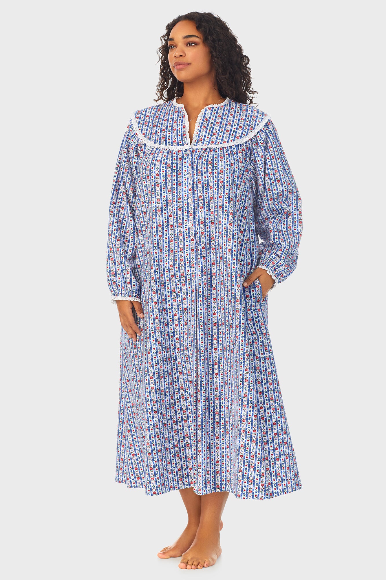 A lady wearing a blue long sleeve flannel nightgown plus with tyrolean stripe pattern.