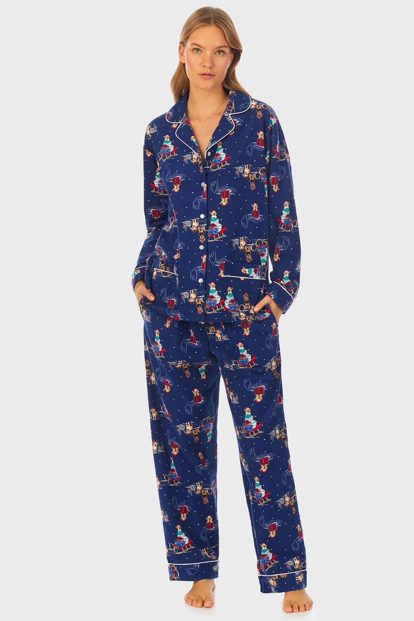 A lady wearing navy long sleeve women's pajama with sleigh puppies print.