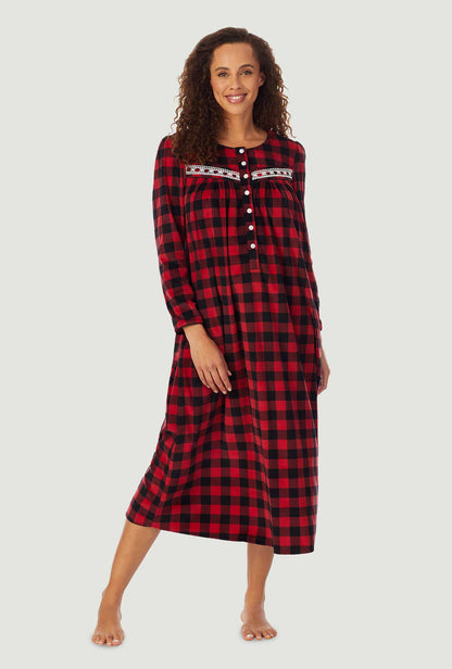 A lady wearing a red check long sleeve cozy fleece gown.
