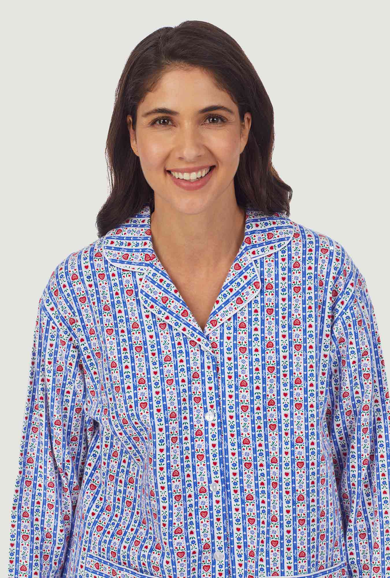 A lady wearing a blue long sleeve flannel pajama with tyrolean stripe pattern.