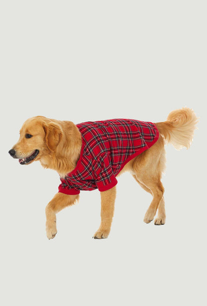 A dog wearing a red plaid short sleeve pajama.