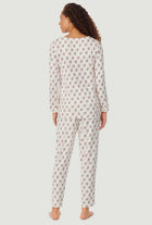 A lady wearing a lanz wreath long sleeve cozy sweater knit henley pajama.