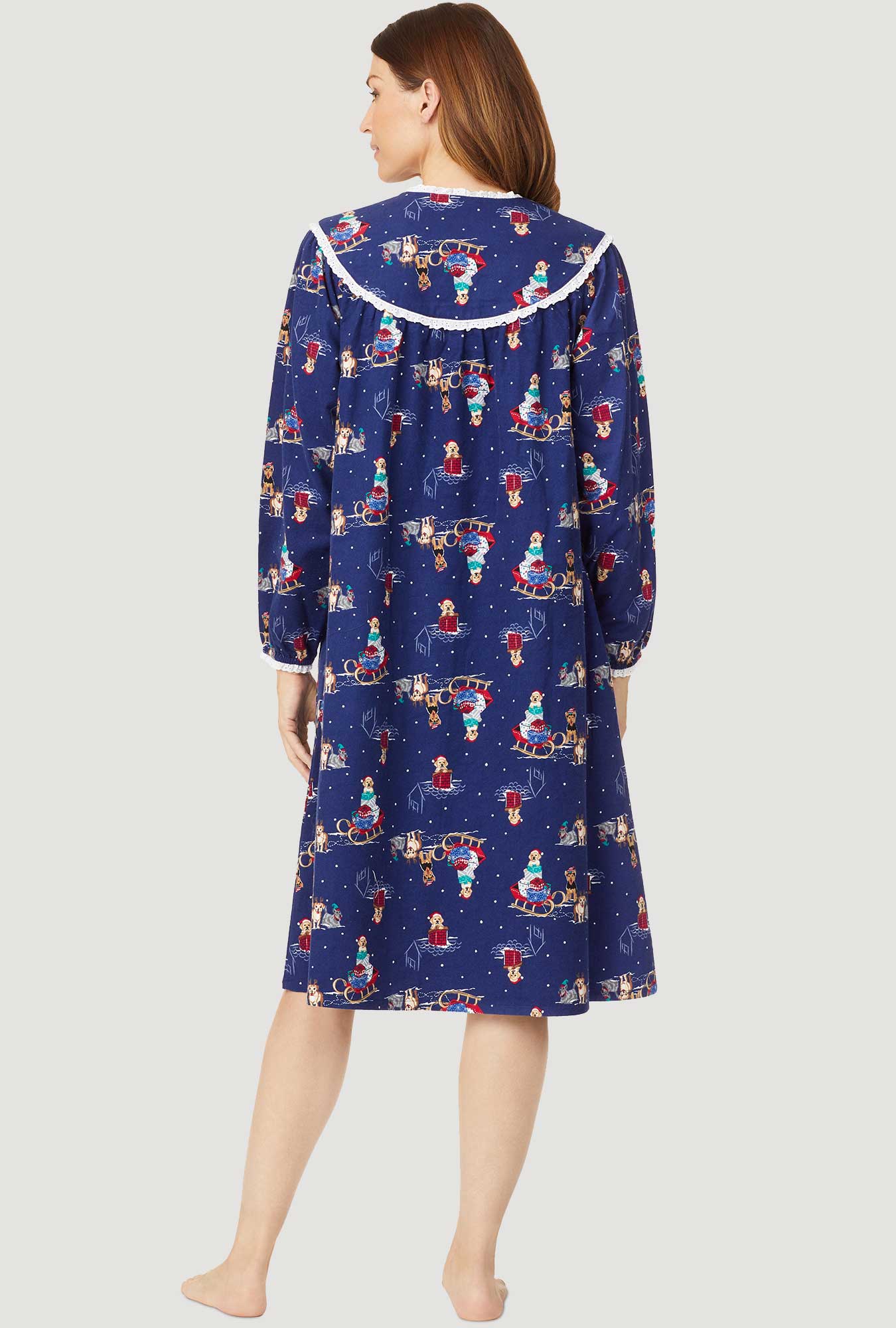 A lady wearing navy long sleeve waltz flannel down with sleigh puppies print.