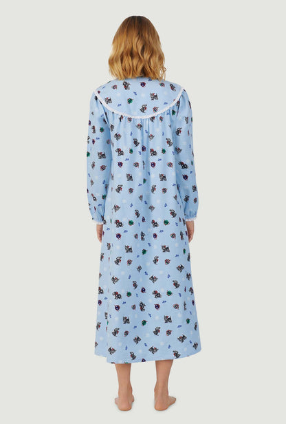 A lady wearing blue long sleeve gown with scottie dogs on parade print.