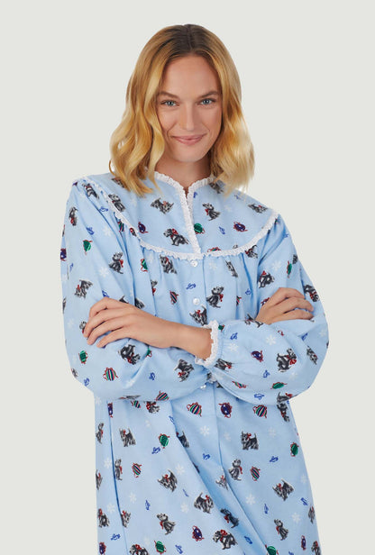 A lady wearing blue long sleeve gown with scottie dogs on parade print.