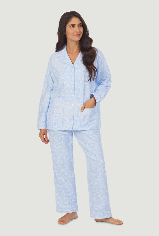 A lady wearing light blue pajama with white pattern