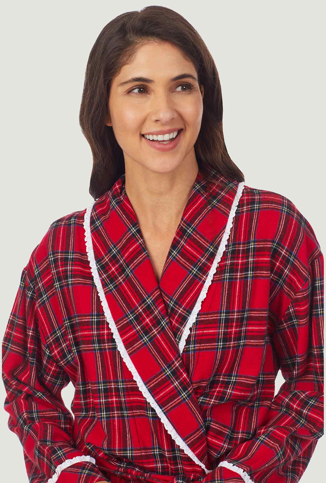 A lady wearing a red long sleeve tartan plaid flannel robe.