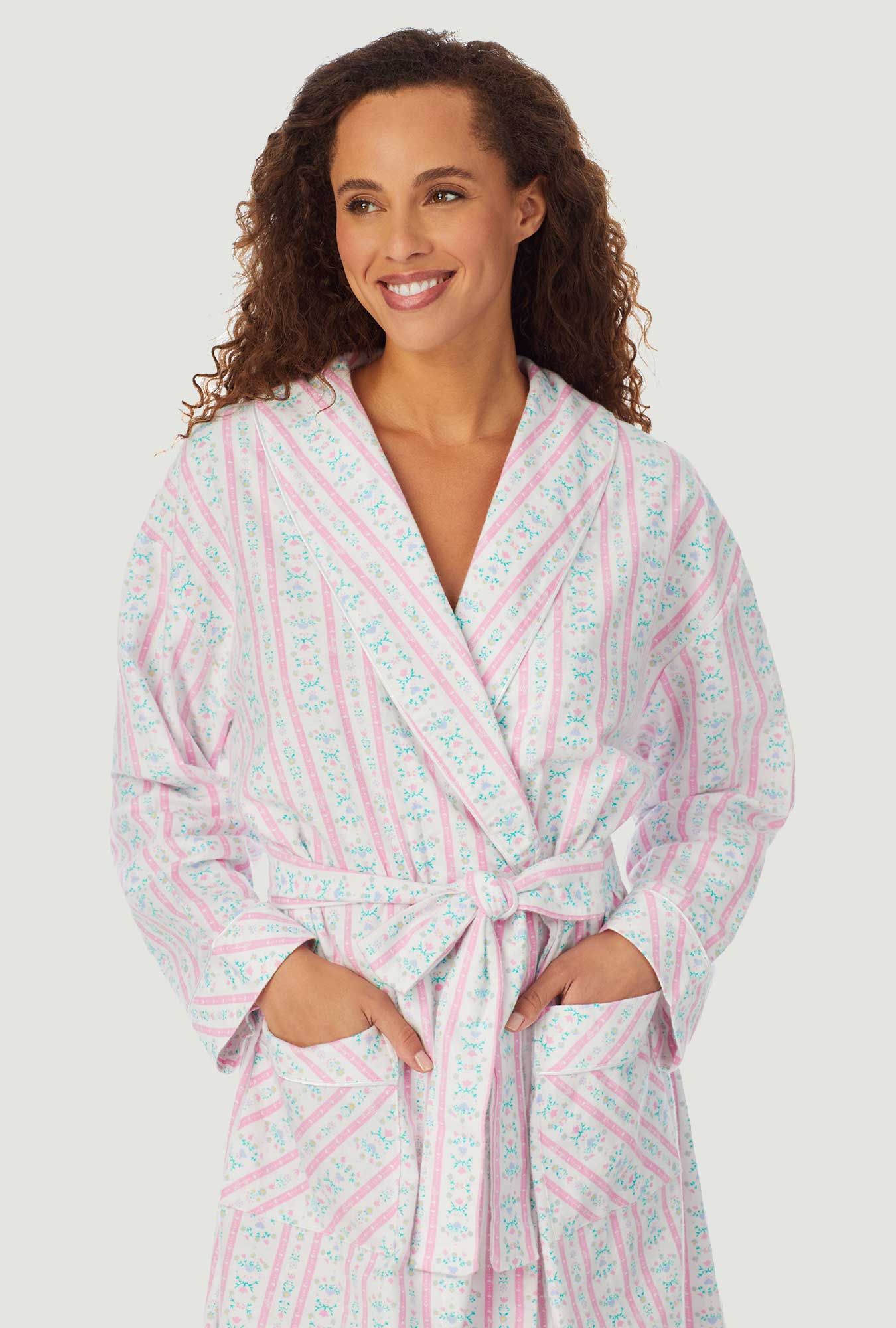A lady wearing a pink tyrolean long sleeve classic wrap robe.