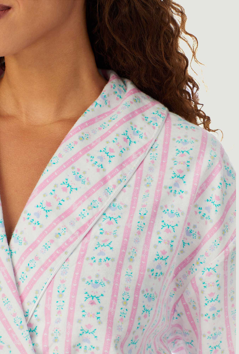 A lady wearing a pink tyrolean long sleeve classic wrap robe.