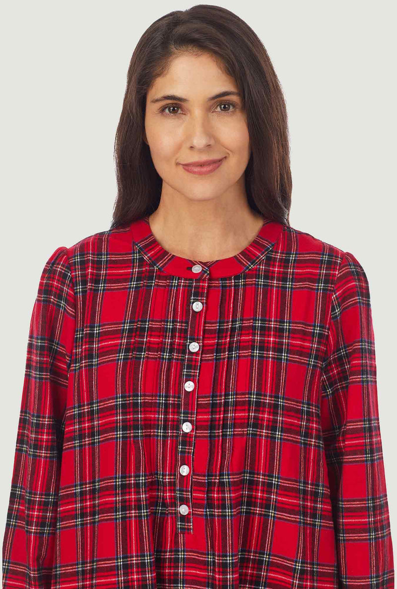 A lady wearing a red tartan long sleeve sweet and simple flannel gown.