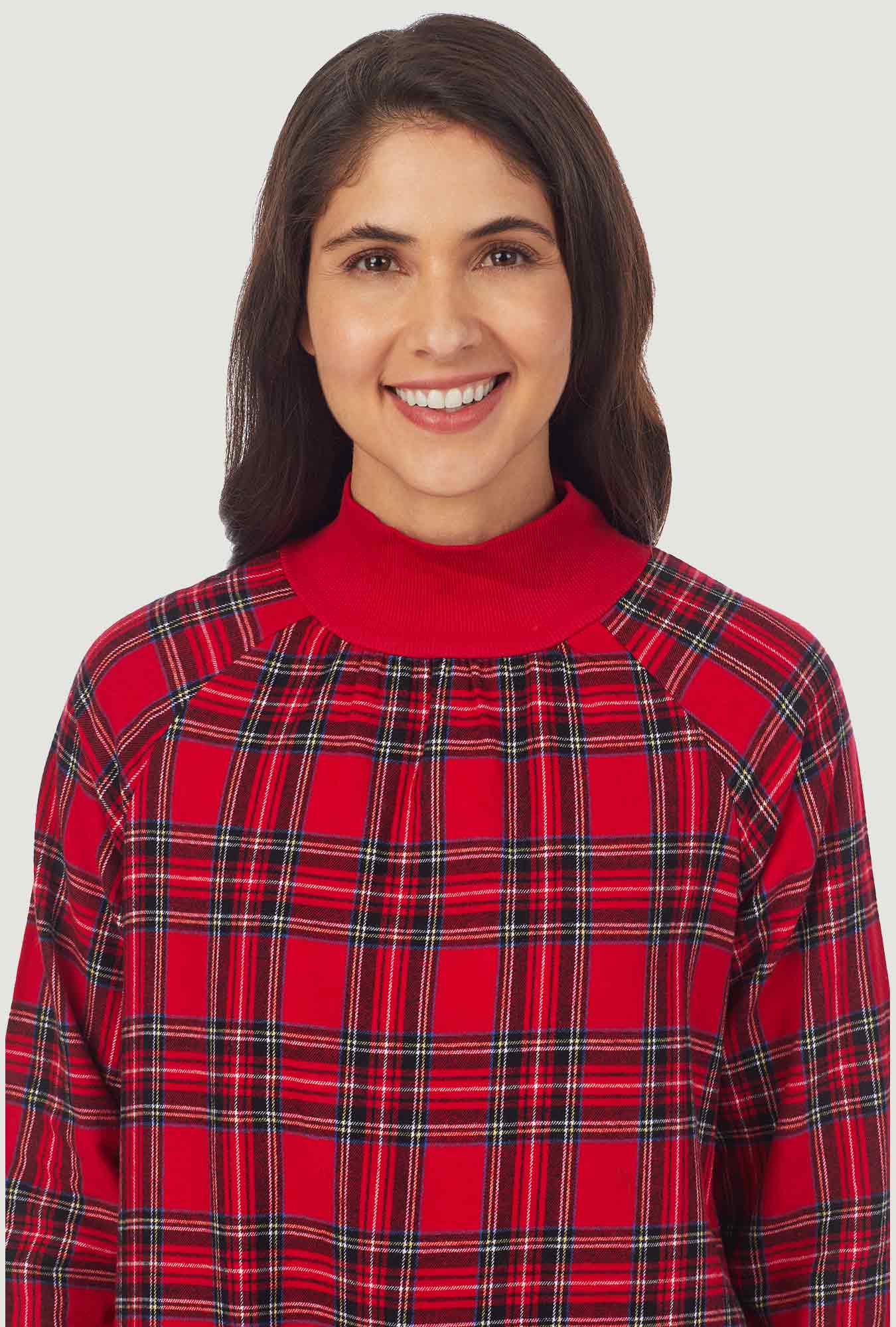  A lady wearing a red tartan long sleeve pop over flannel gown.