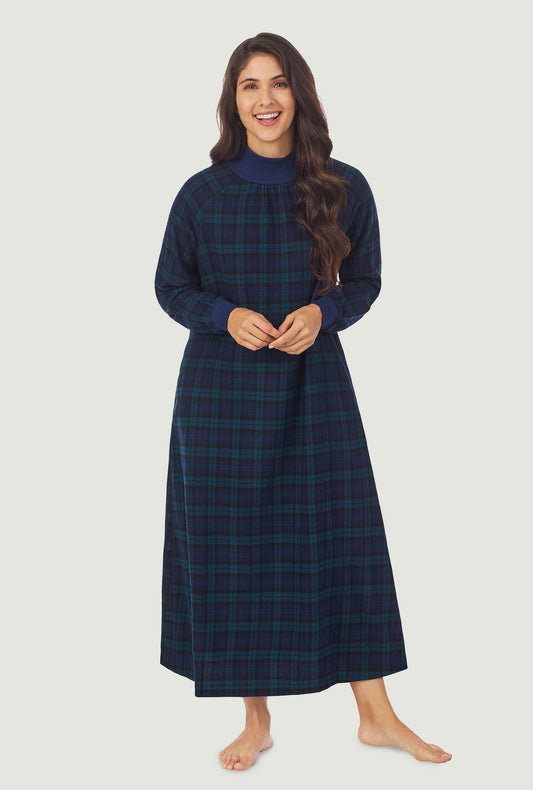 A lady wearing a black watch plaid long sleeve flannel pop over gown.