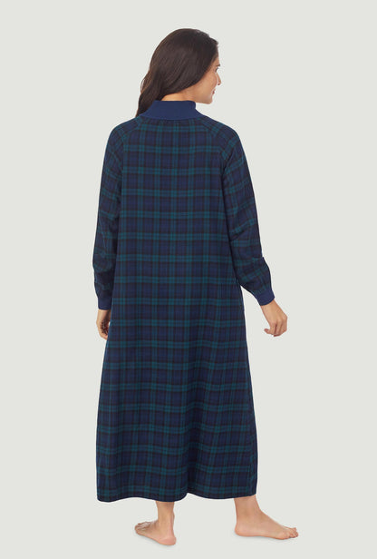 A lady wearing a black watch plaid long sleeve flannel pop over gown.