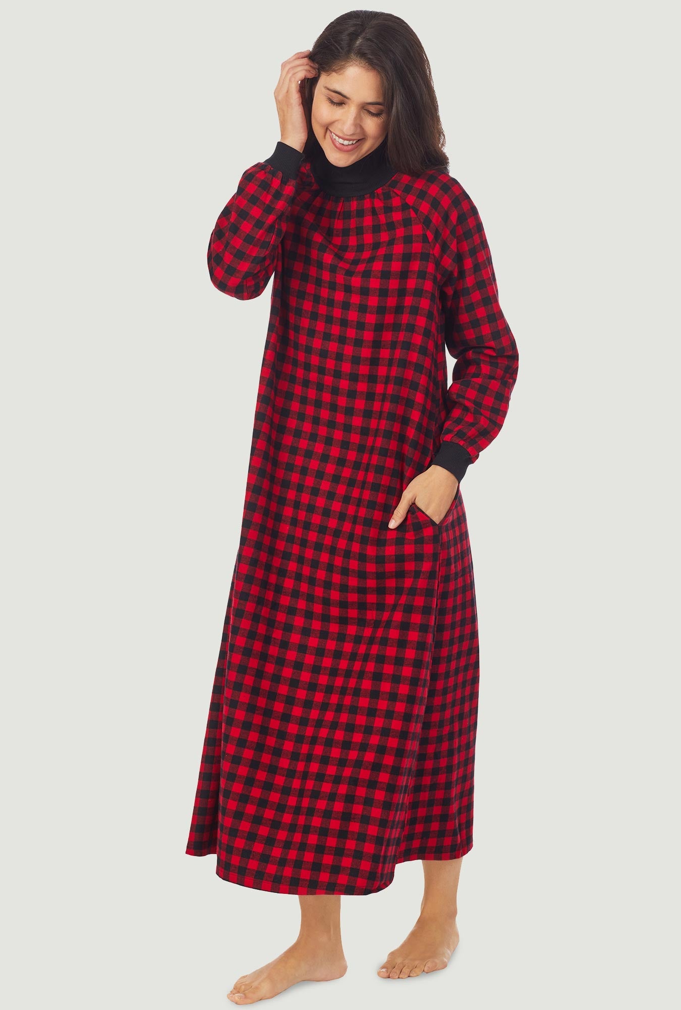 A lady wearing a red buffalo check long sleeve pop over flannel gown.