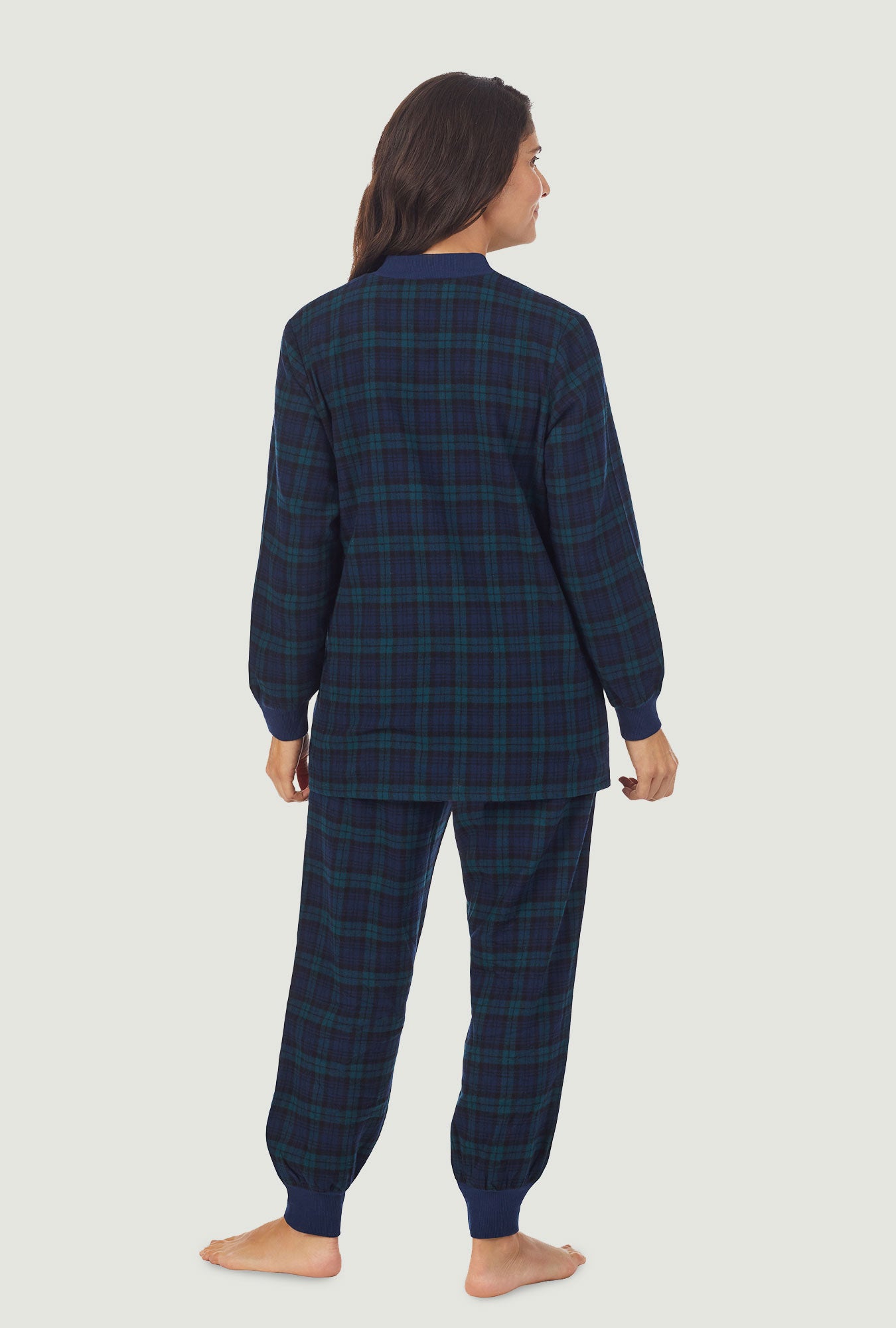 A lady wearing a long sleeve pajama with black watch plaid  pattern.