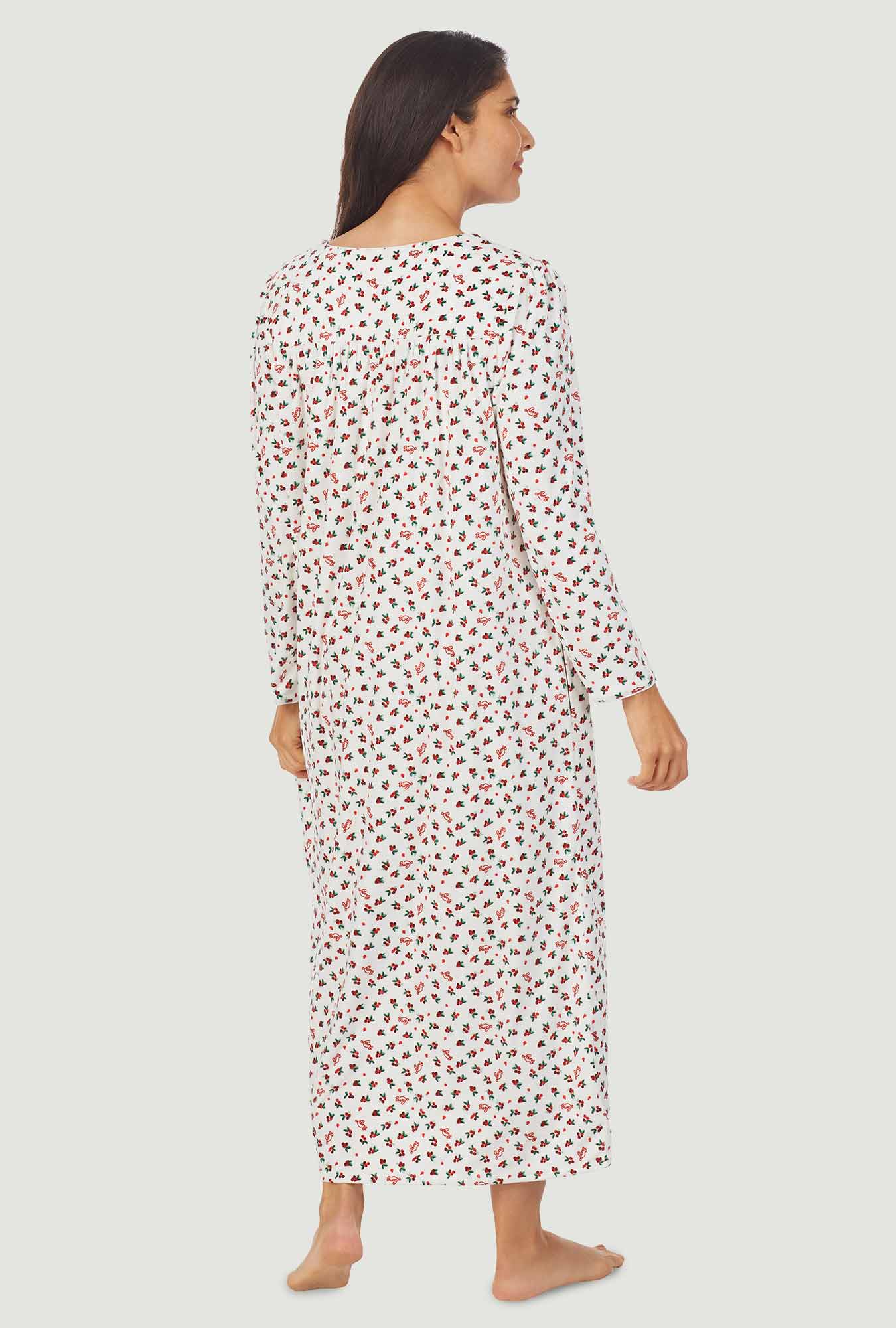 A lady wearing a lanz berry floral long sleeve cozy fleece gown.