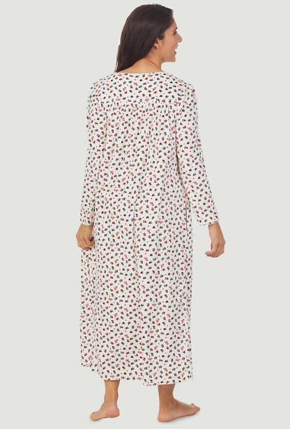 A lady wearing a lanz berry floral long sleeve cozy fleece gown.