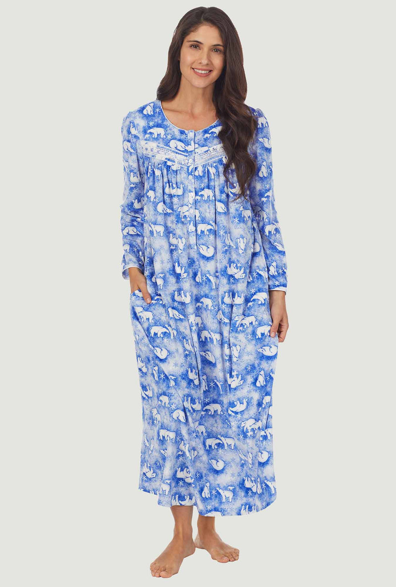   A lady wearing a polar bears long sleeve cozy fleece gown.