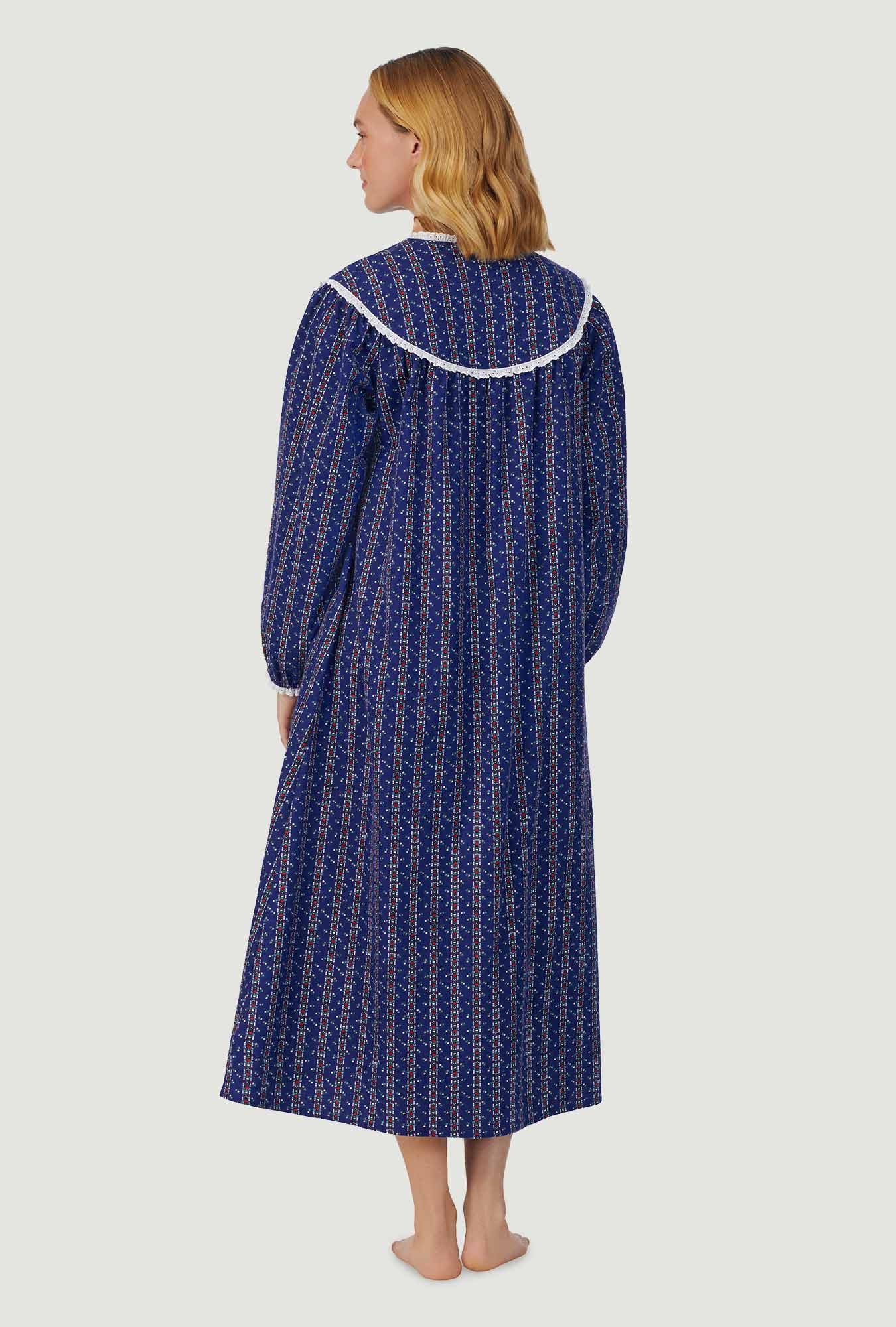 A lady wearing navy long sleeve gown with vintage navy heart stripe print.