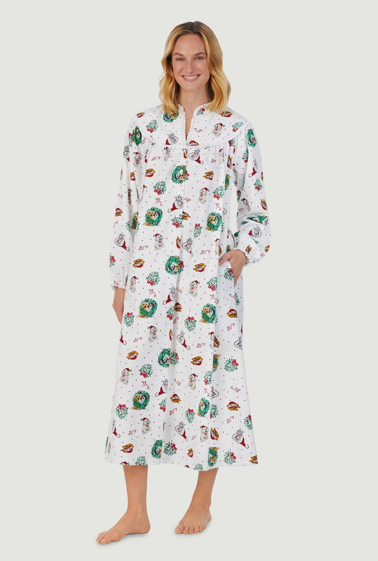 A lady wearing white long sleeve flannel gown with holiday puppies print.