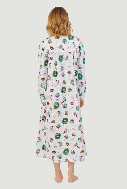A lady wearing white long sleeve flannel gown with holiday puppies print.