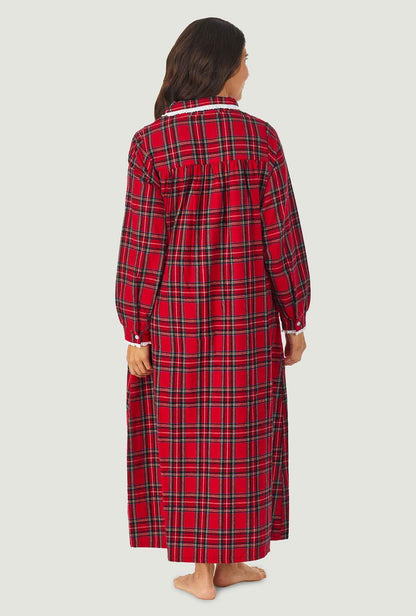 A lady wearing a red tartan long sleeve pan flannel gown.
