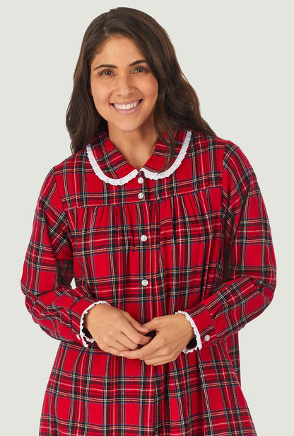 A lady wearing a red tartan long sleeve pan flannel gown.