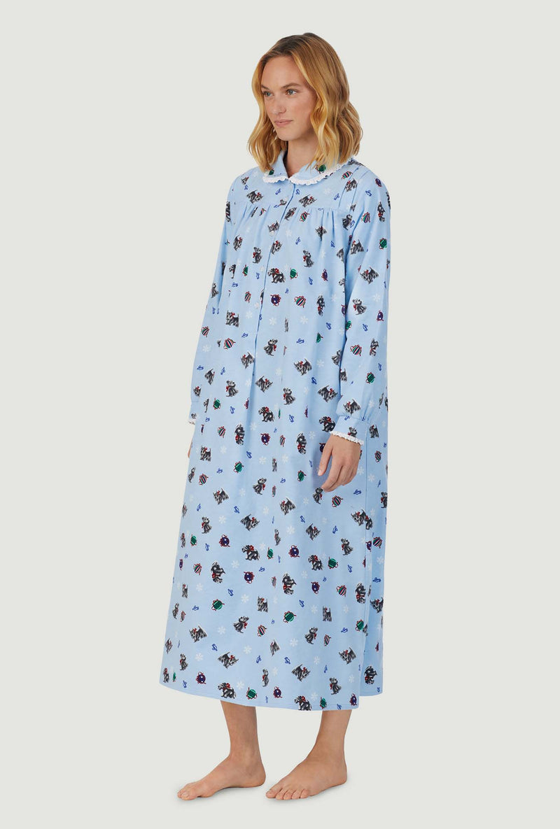 A lady wearing blue peter pan flannel gown with scottie dogs on parade print.