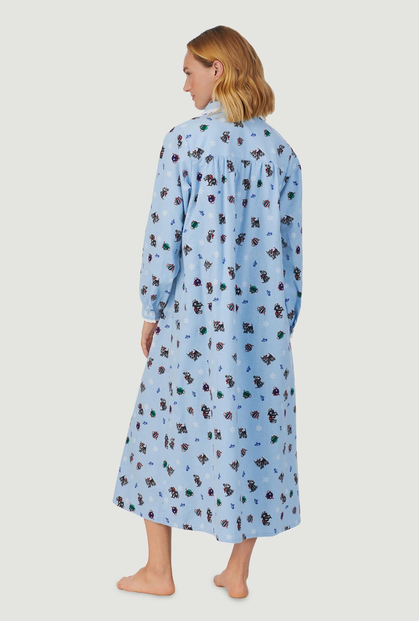 A lady wearing blue peter pan flannel gown with scottie dogs on parade print.