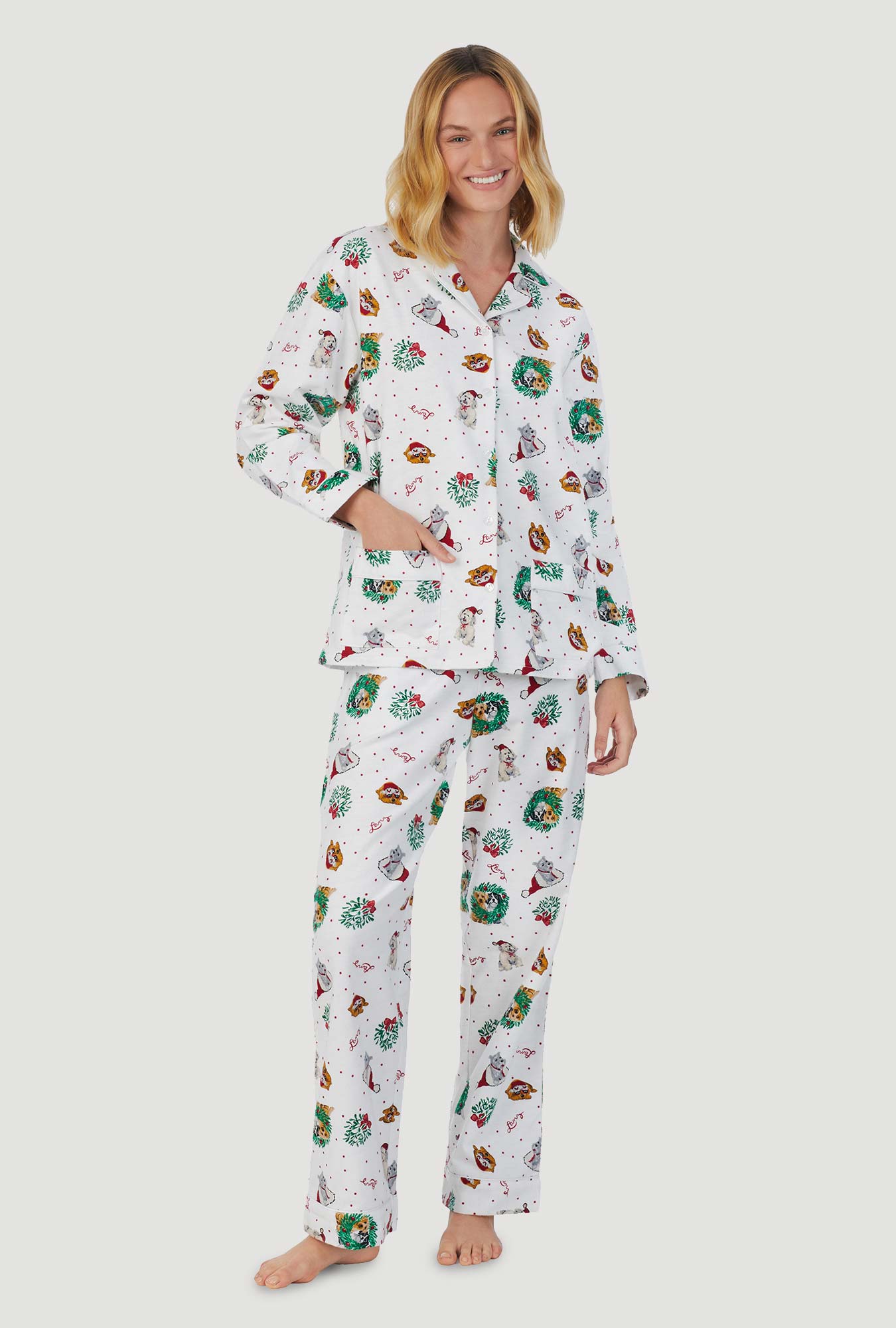 A lady wearing white long sleeve classic notch pajama with holiday puppies print.