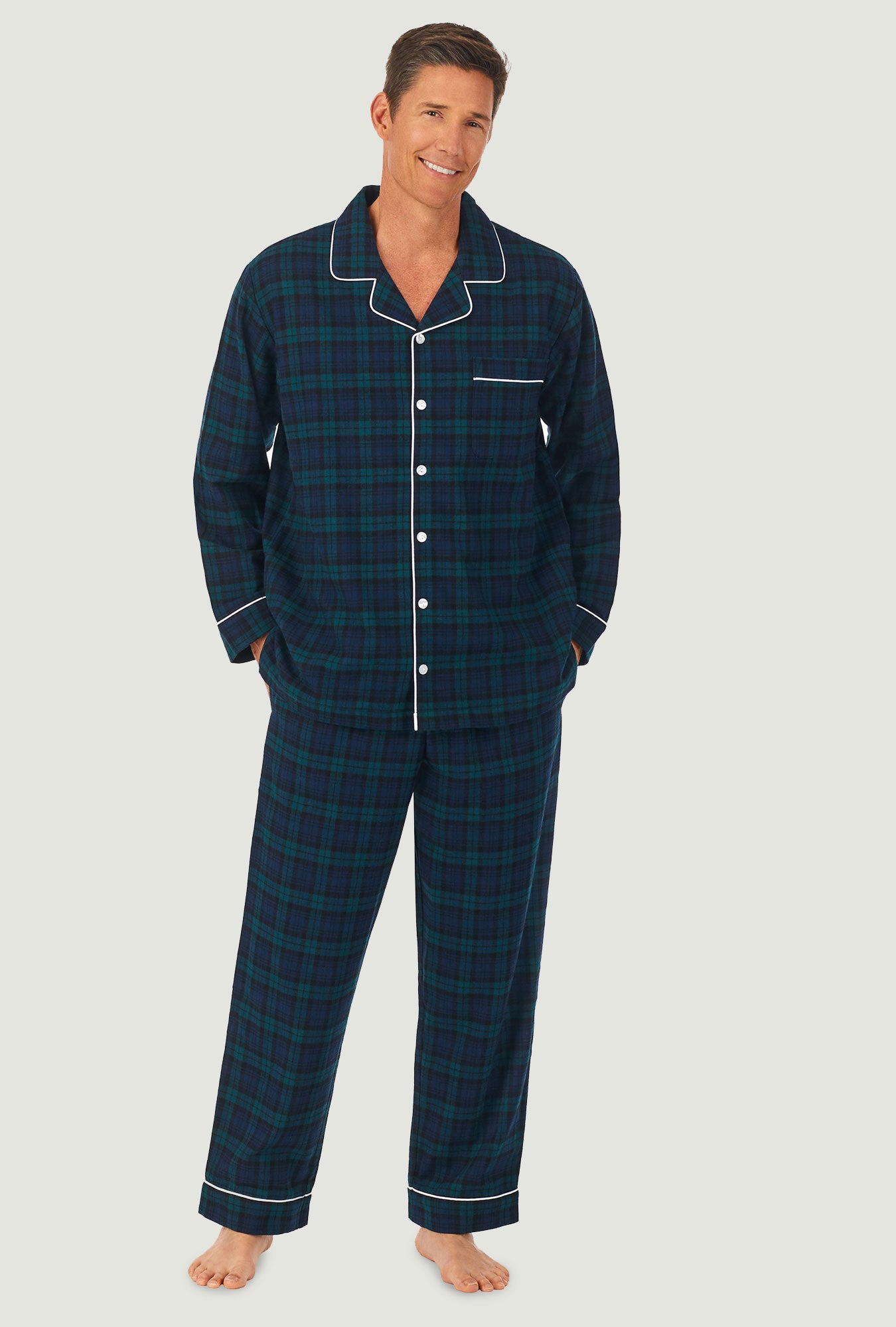 A man wearing a black watch men's flannel pajama.