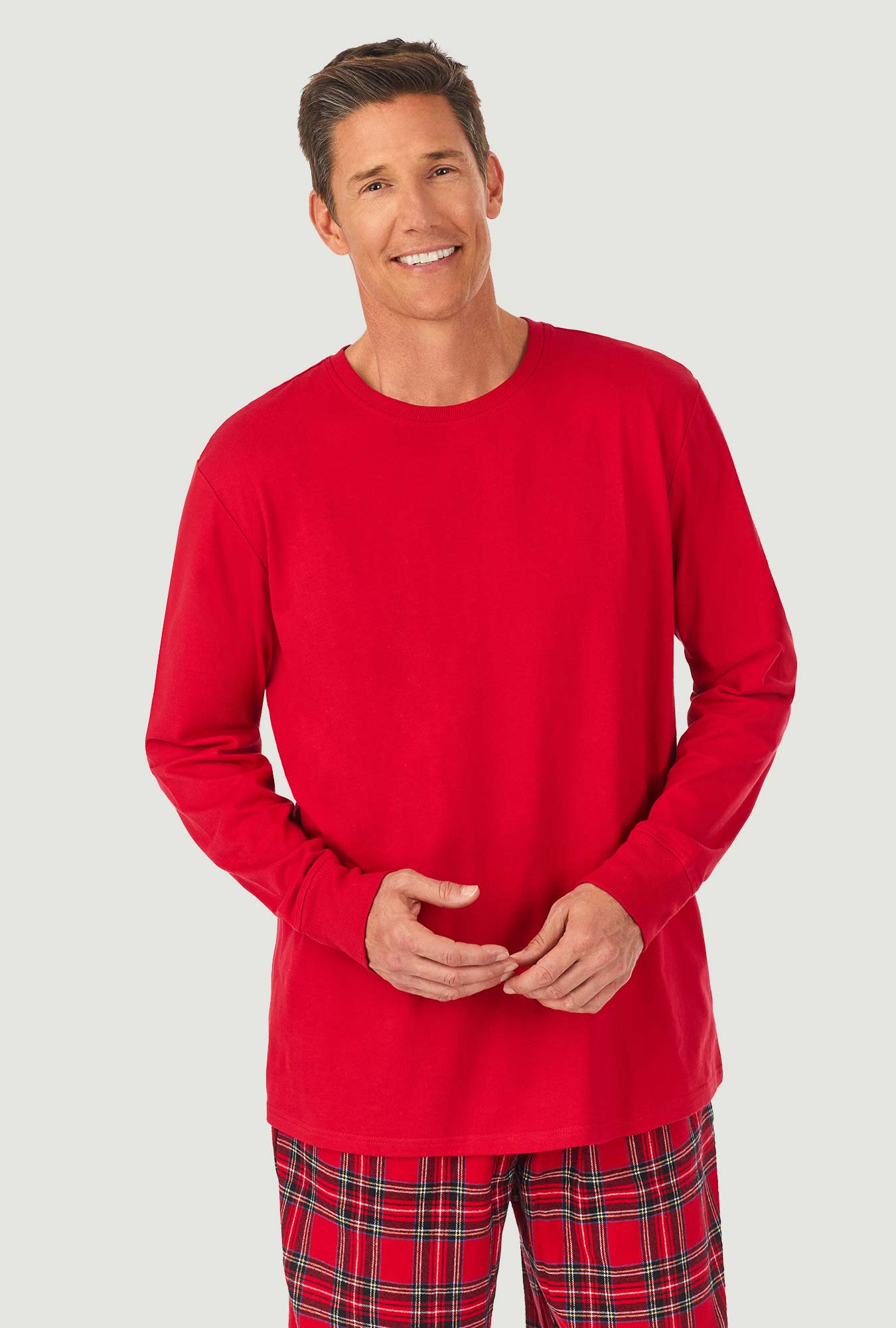 A man wearing a red tartan long sleeve knit & flannel pj set.