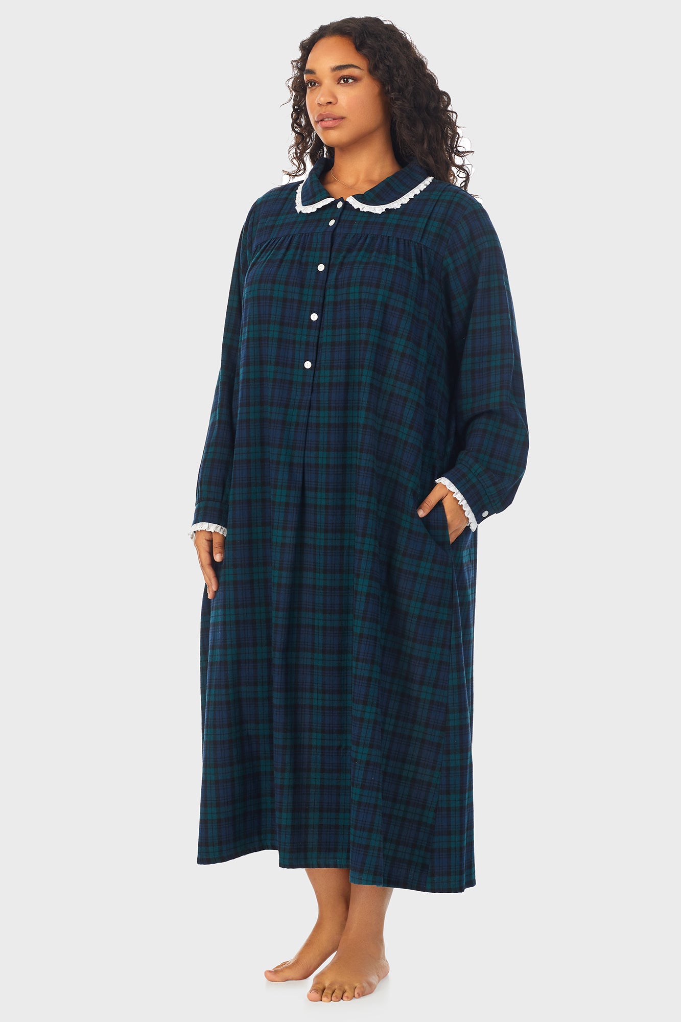  A lady wearing a long sleeve flannel gown plus with black watch peterpan pattern.