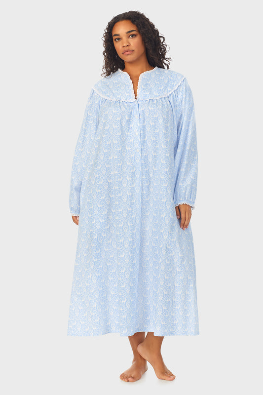 A lady wearing a blue long sleeve flannel gown plus with floral pattern.