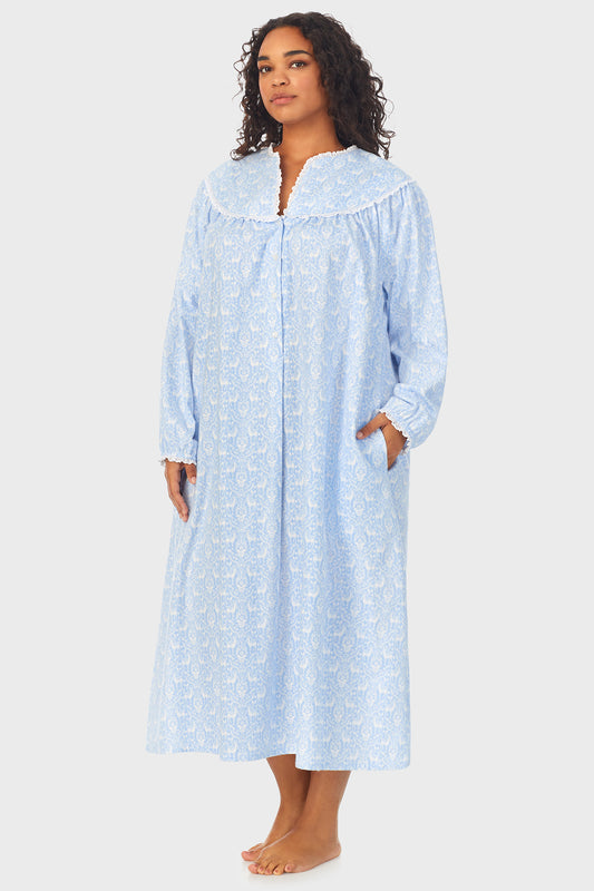 A lady wearing a blue long sleeve flannel gown plus with floral pattern.