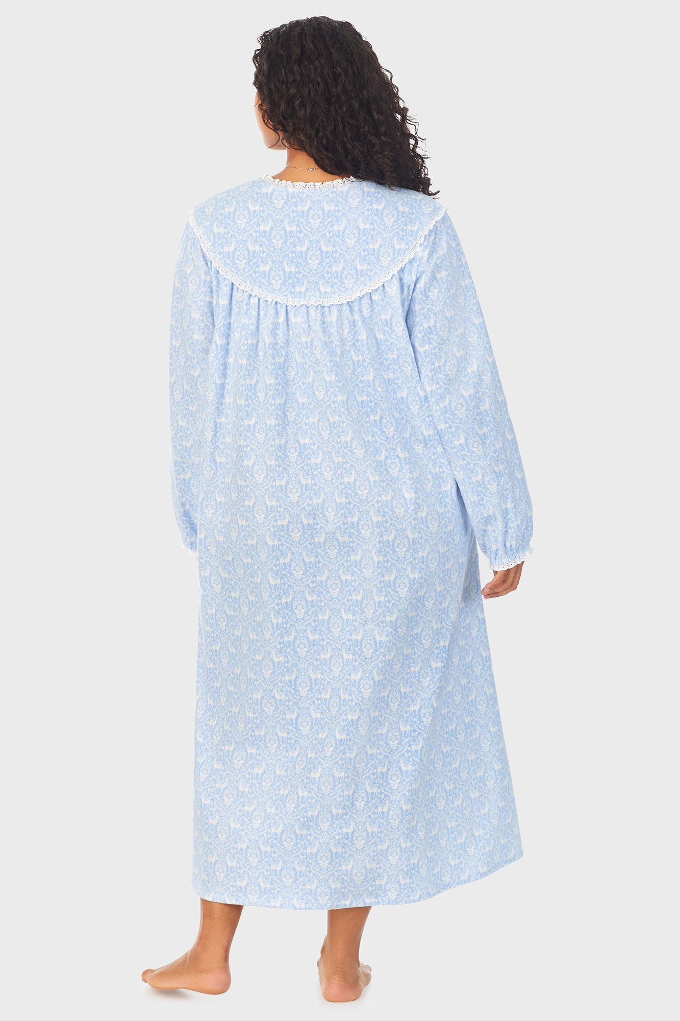 A lady wearing a blue long sleeve flannel gown plus with floral pattern.