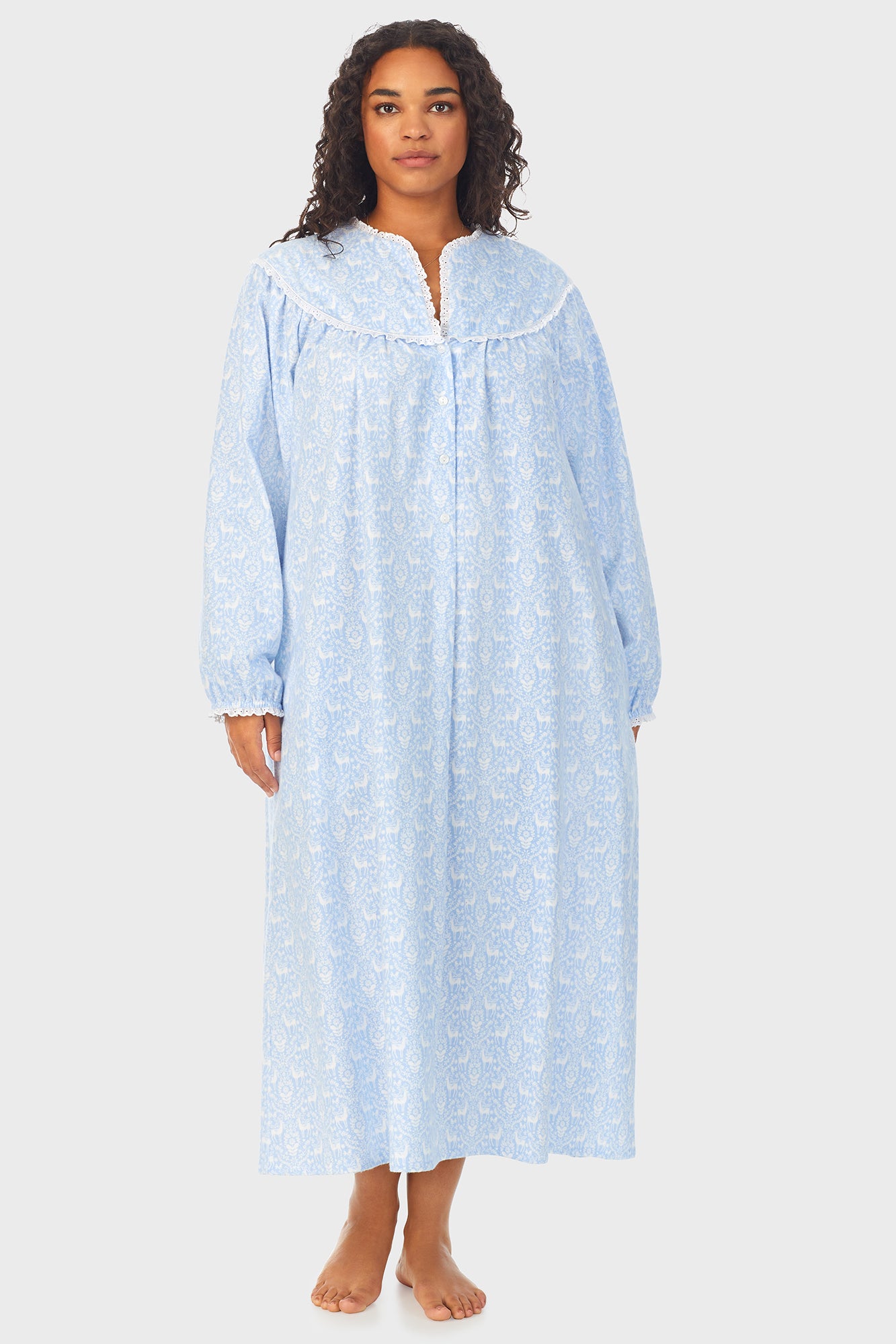 A lady wearing a blue long sleeve flannel gown plus with floral pattern.