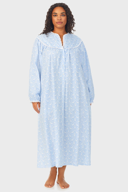 A lady wearing a blue long sleeve flannel gown plus with floral pattern.