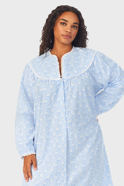 A lady wearing a blue long sleeve flannel gown plus with floral pattern.
