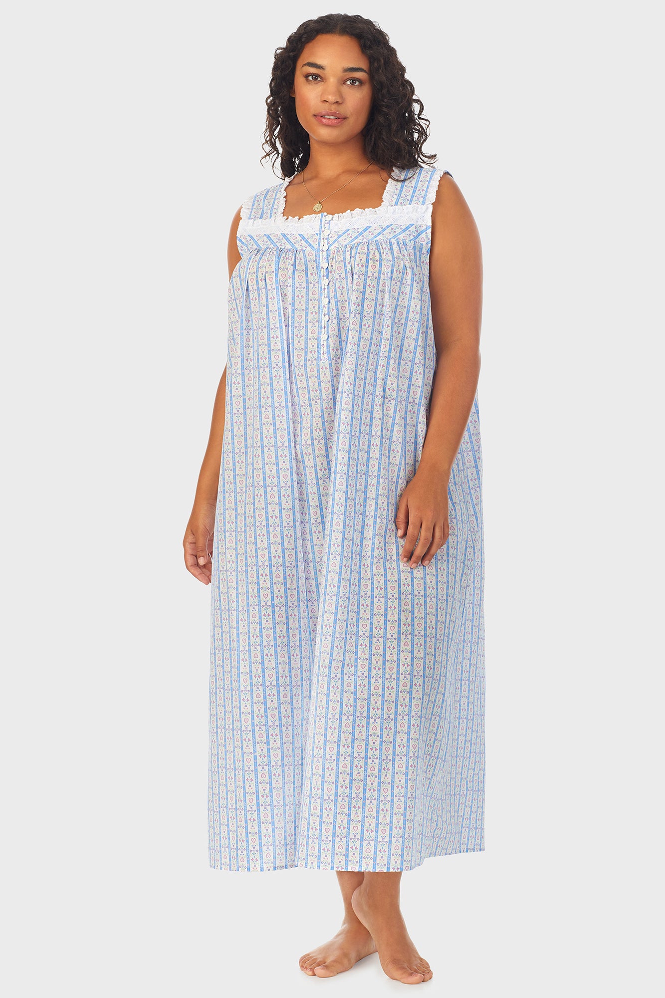 A lady wearing white long nightgown with blue pattern